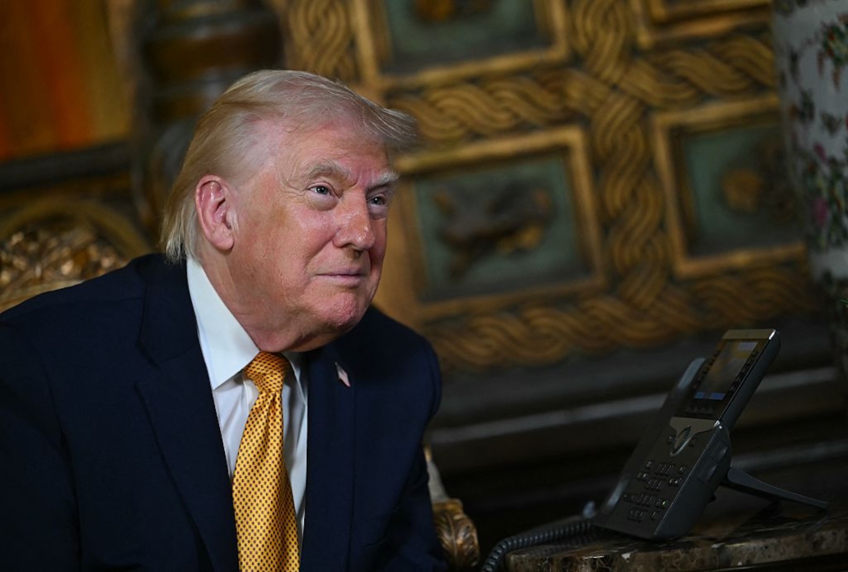 US President Donald Trump participates in NORAD Santa tracker phone calls, on Christmas Eve, from the Mar-a-lago club in Palm Beach, Florida, on December 24, 2025. (Photo by ANDREW CABALLERO-REYNOLDS / AFP)
