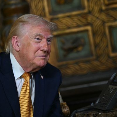 US President Donald Trump participates in NORAD Santa tracker phone calls, on Christmas Eve, from the Mar-a-lago club in Palm Beach, Florida, on December 24, 2025. (Photo by ANDREW CABALLERO-REYNOLDS / AFP)